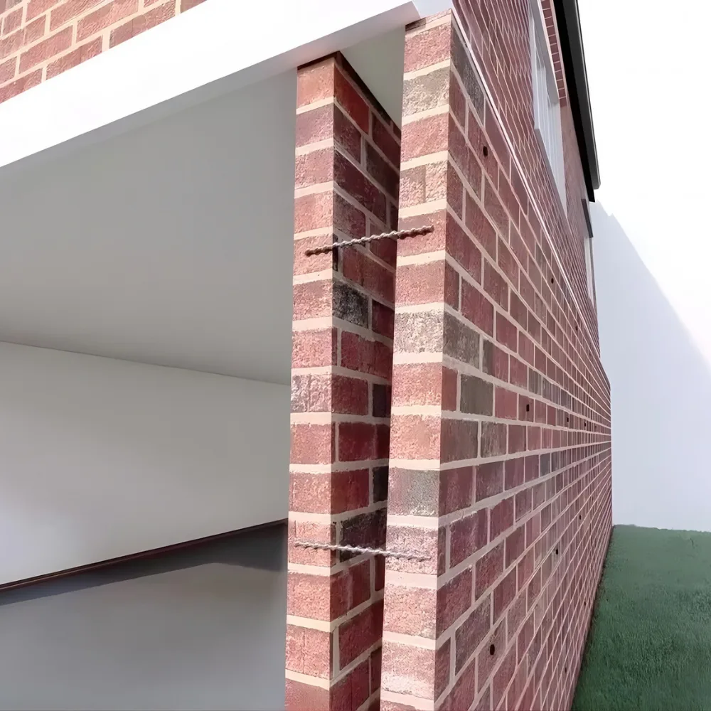 Remedial wall ties — HelicalBar™ stainless steel ties securing a leaning external brick wall