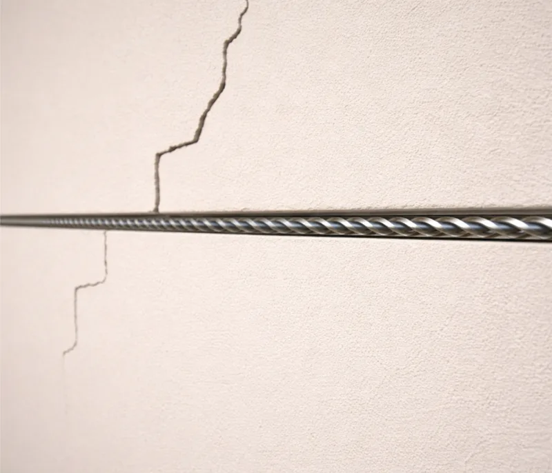 Plaster wall repair — HelicalBar™ reinforcement behind the wall, then skim and paint-ready finish